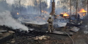 Firefighters work to extinguish a wildfire in the outskirts of Ridder